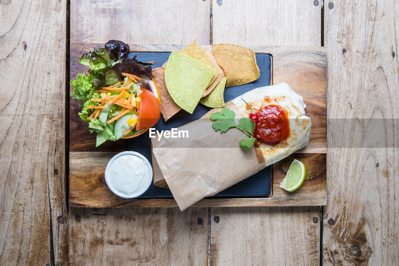 HIGH ANGLE VIEW OF BREAKFAST ON WOODEN TABLE