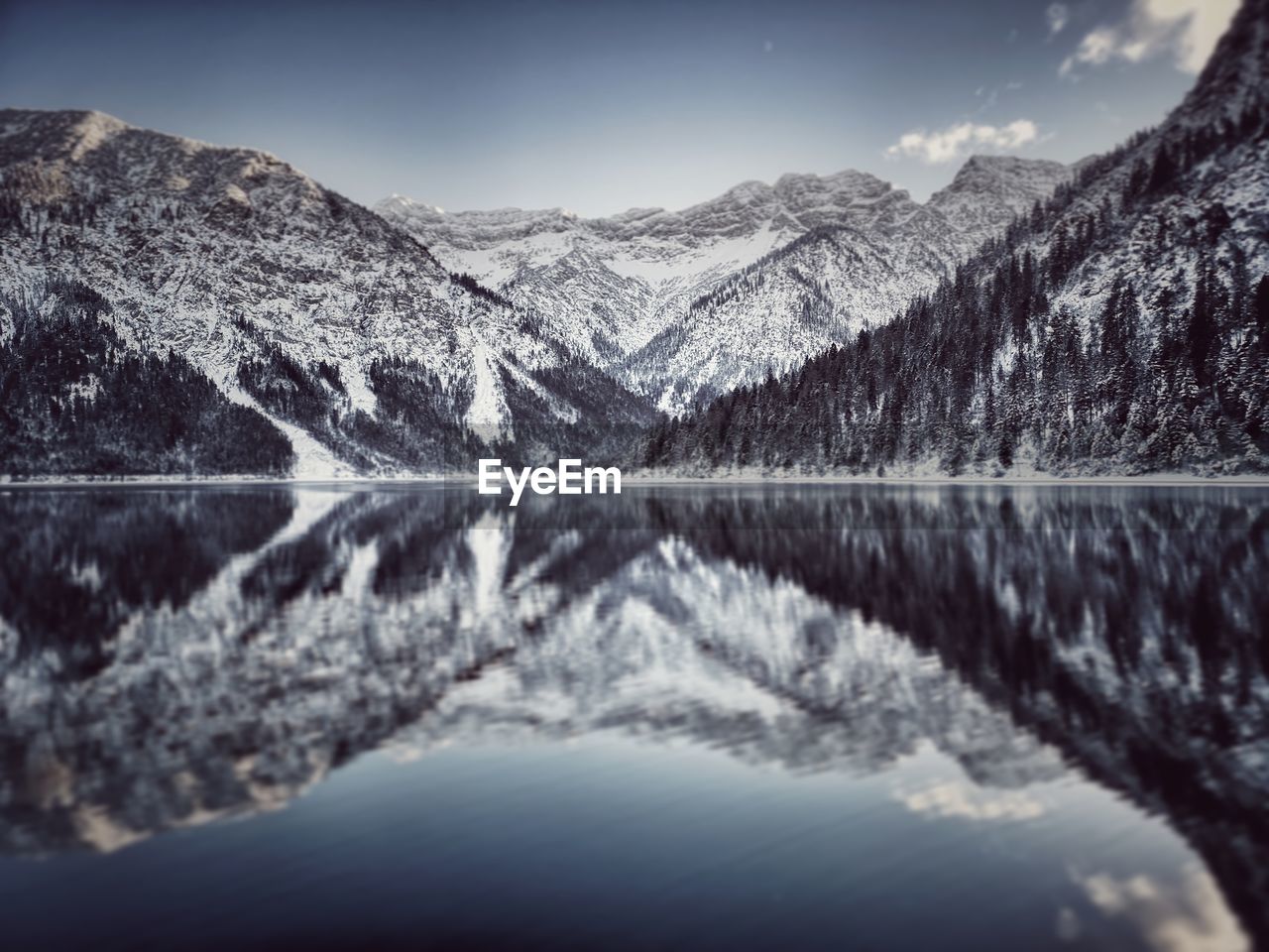 Scenic view of lake and snowcapped mountains against sky