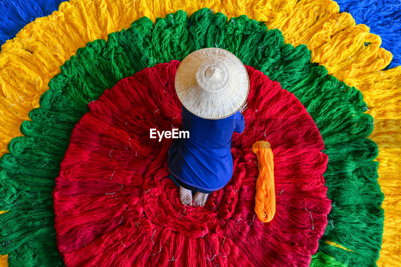 Directly above shot of woman amidst multi colored decoration