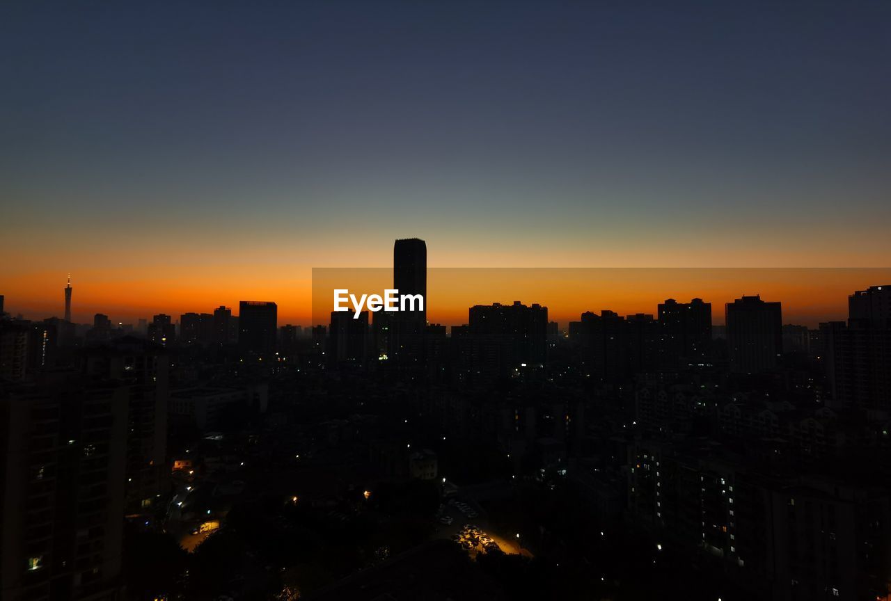 SILHOUETTE BUILDINGS AGAINST SKY AT SUNSET