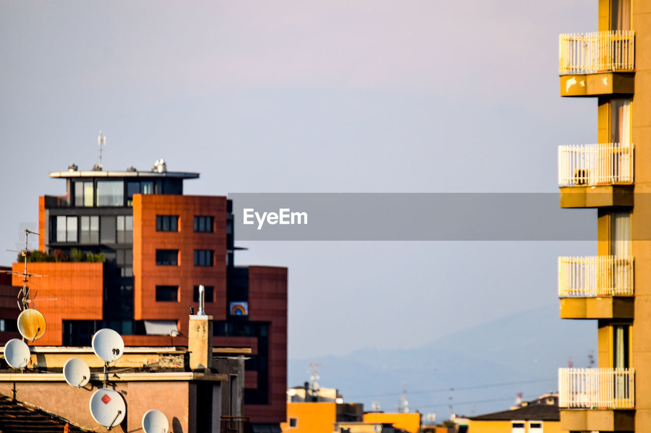 Residential buildings against sky in city