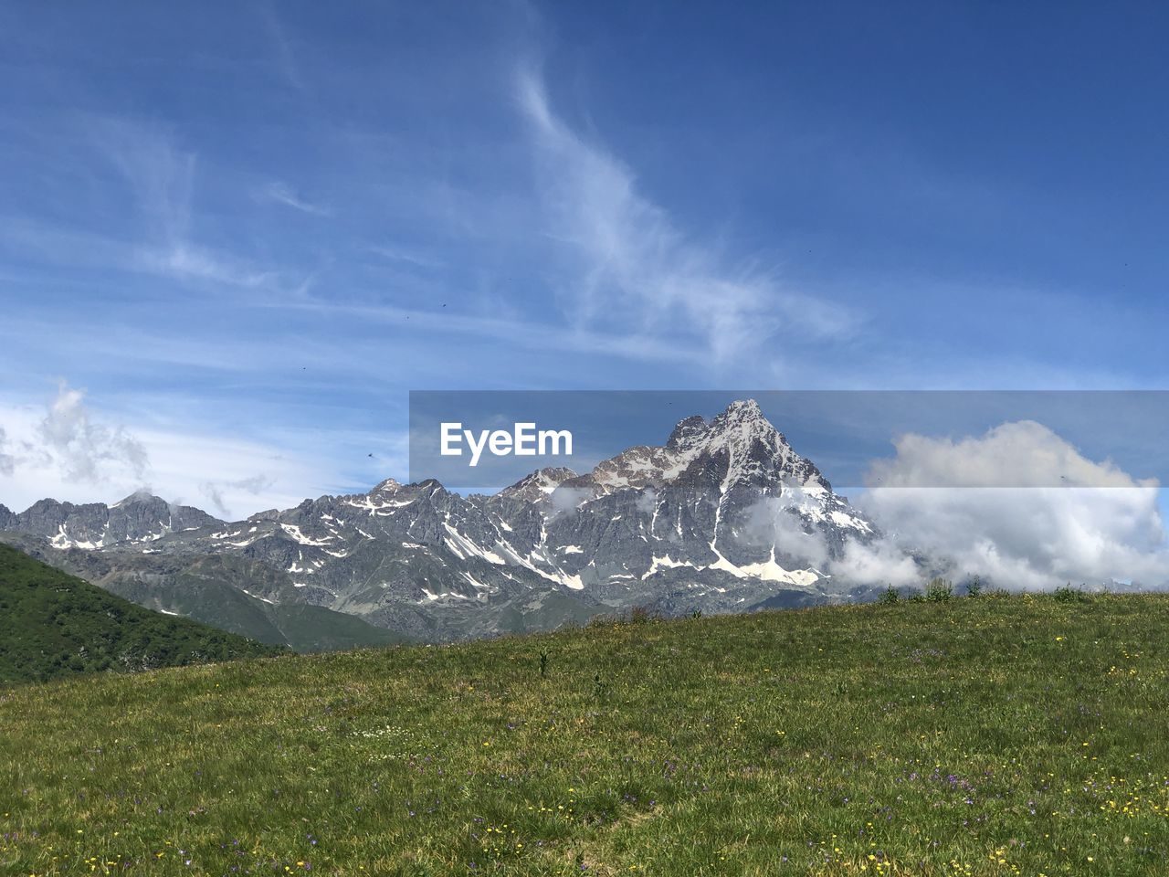 Scenic view of snowcapped mountains against sky