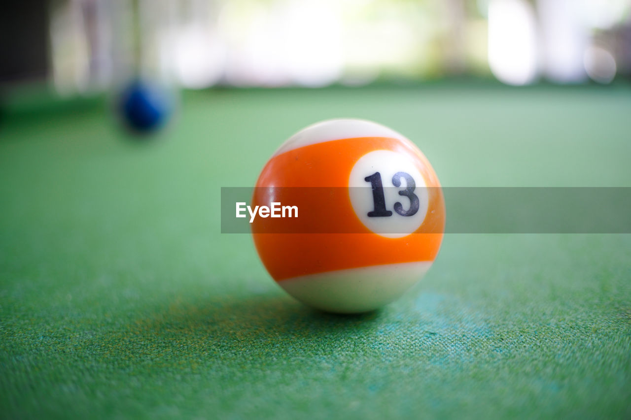 CLOSE-UP OF YELLOW BALL ON TABLE AT PARK