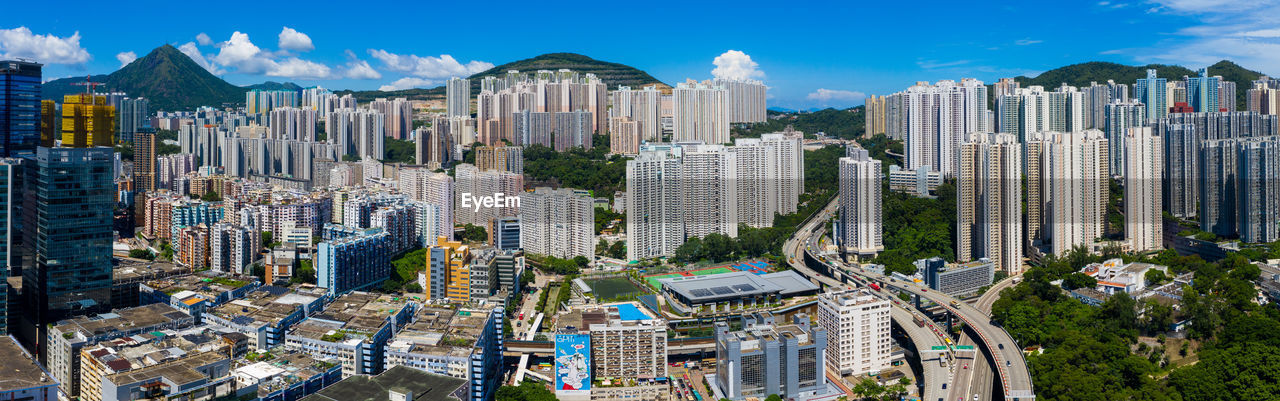 Panoramic view of modern buildings in city against sky