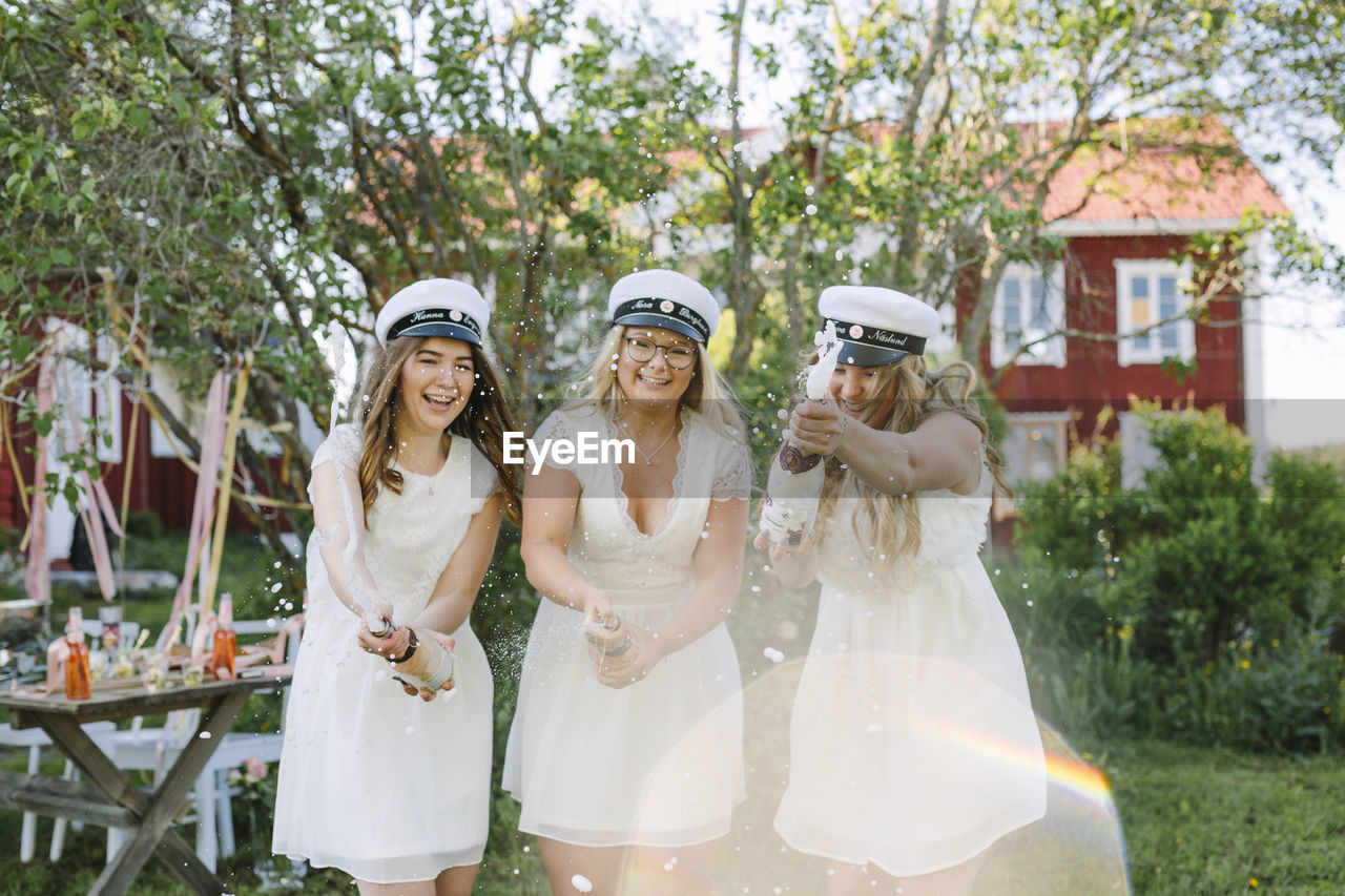 Women celebrating graduation with champagne