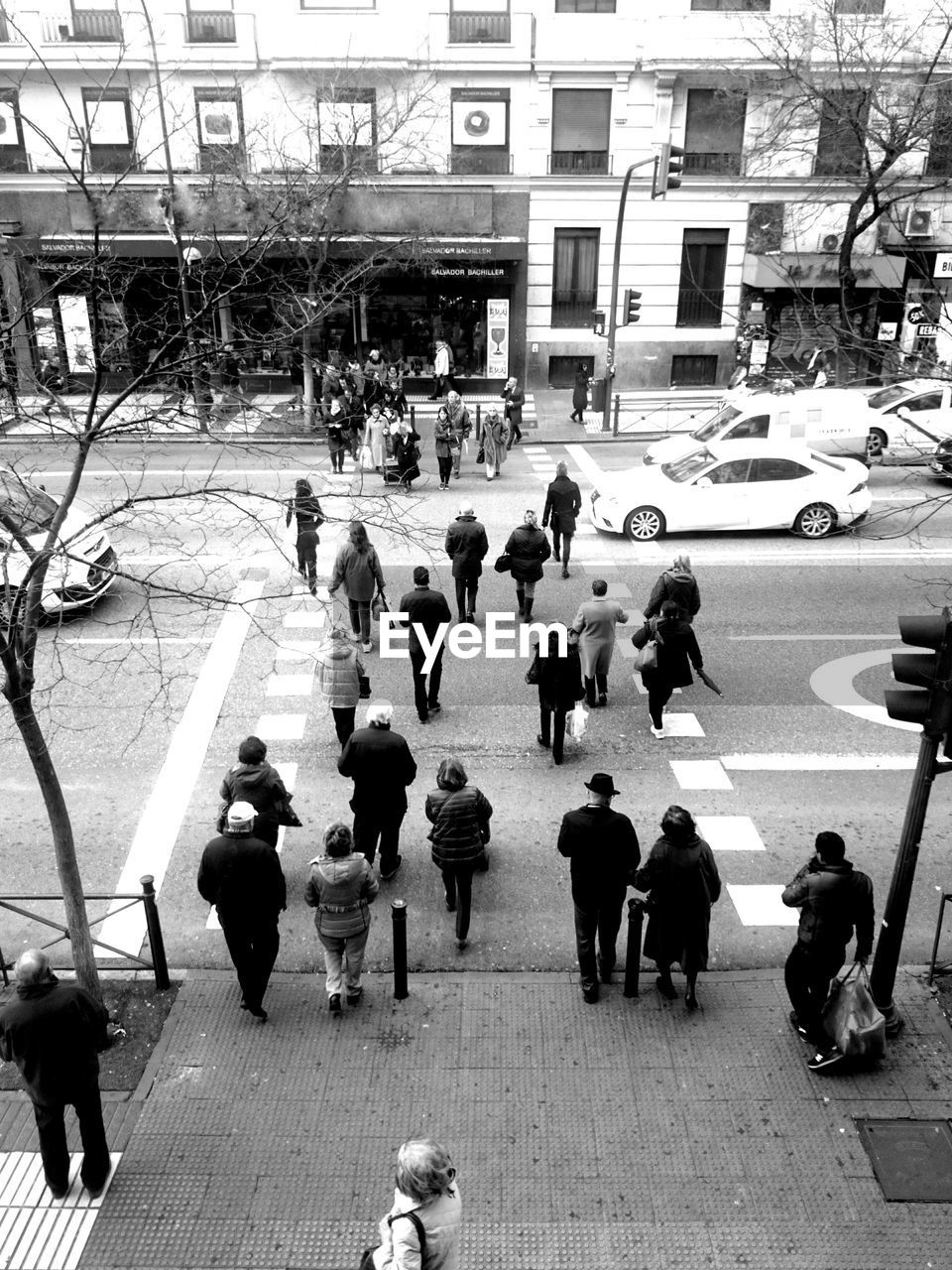 High angle view of people walking on street against building