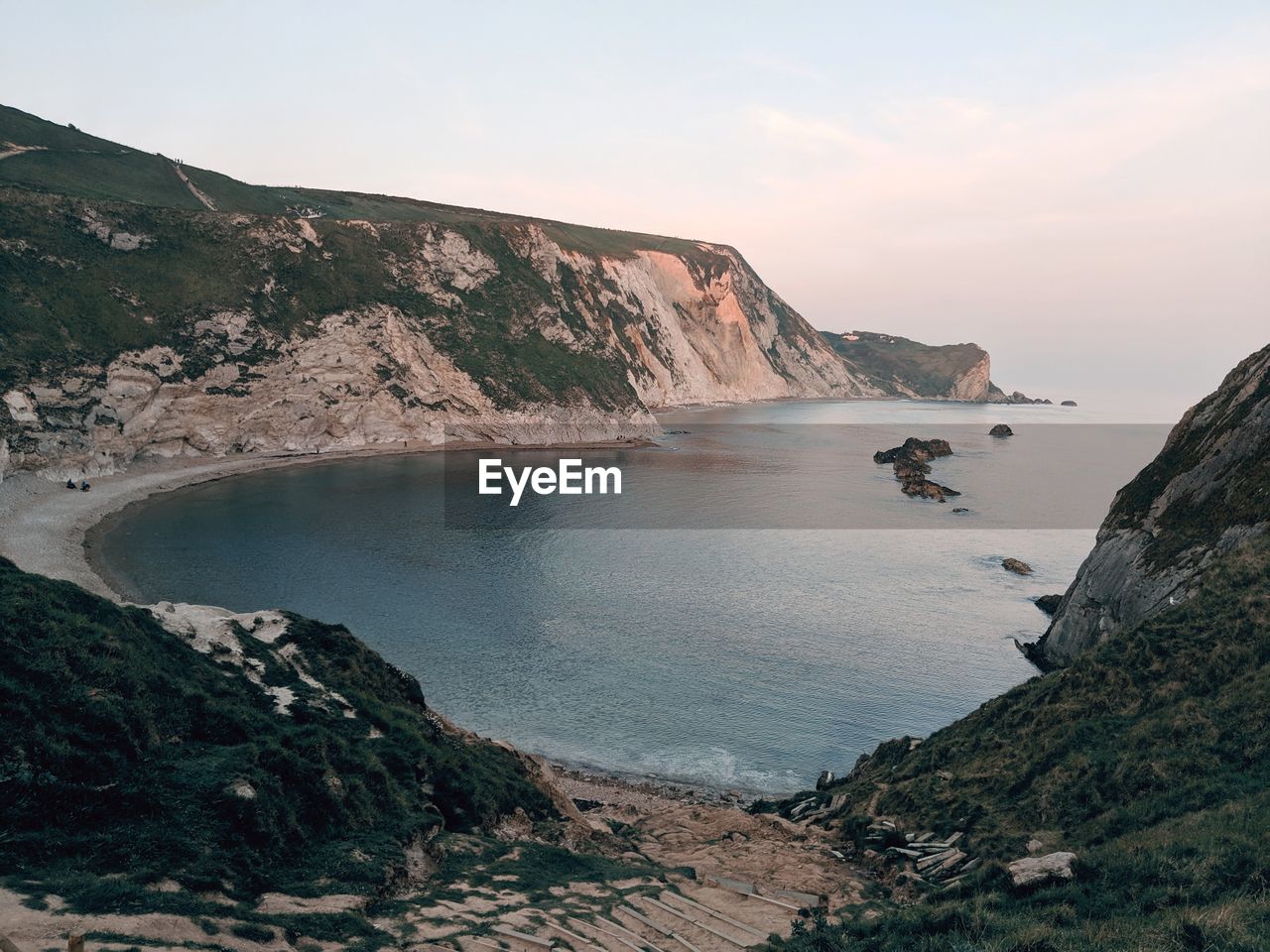 Scenic view of sea and mountains against sky