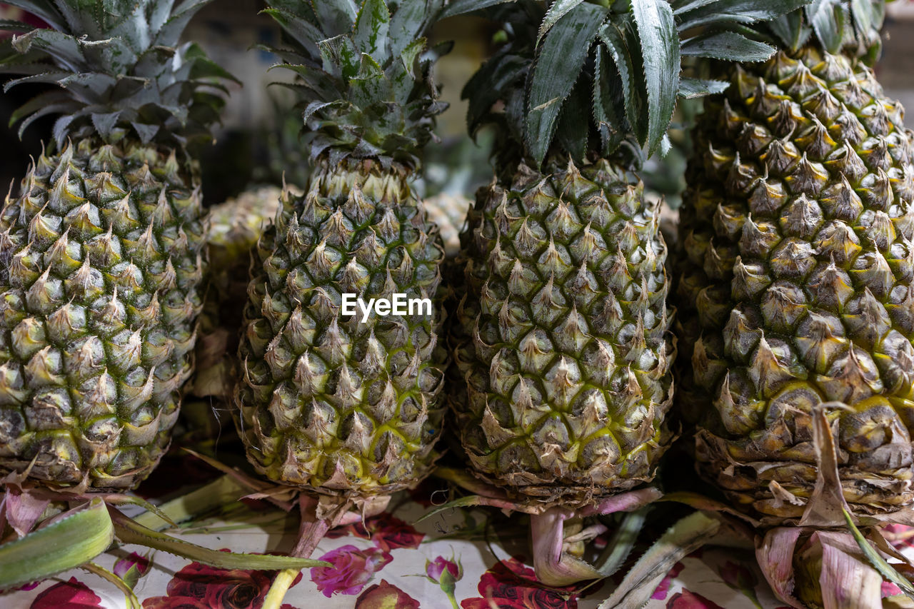pineapple, ananas, food and drink, food, fruit, healthy eating, produce, tropical fruit, freshness, wellbeing, plant, market, bromeliaceae, retail, no people, abundance, for sale, large group of objects, market stall, tropical climate, close-up, business, nature, outdoors, organic, day, variation, raw food