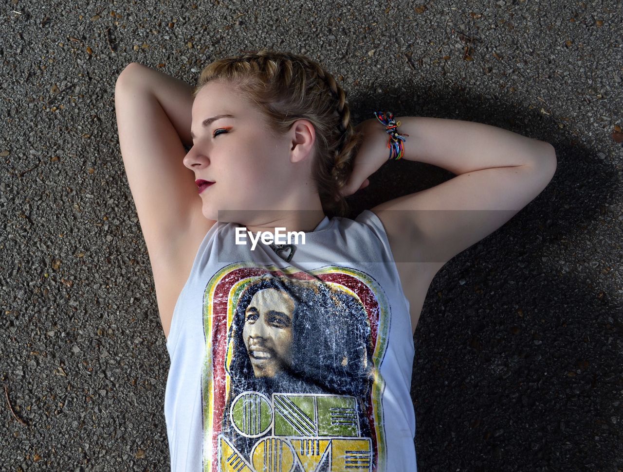 LOW ANGLE VIEW OF GIRL LOOKING AWAY OUTDOORS