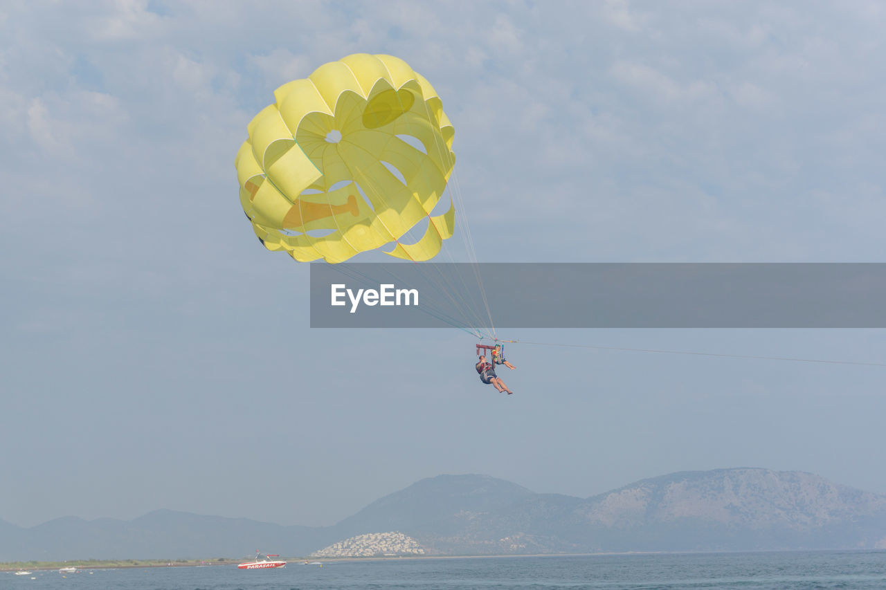 LOW ANGLE VIEW OF KITES FLYING IN SKY