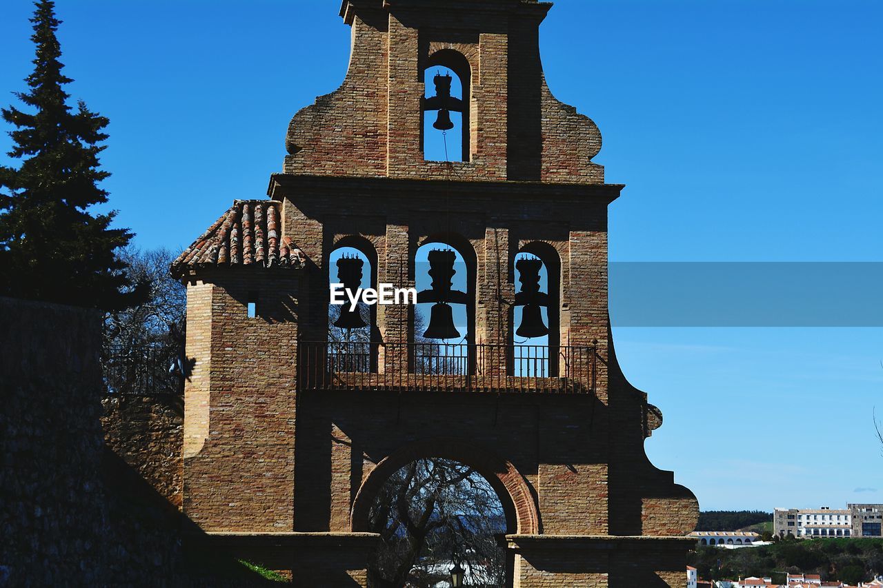 Bell tower against clear blue sky