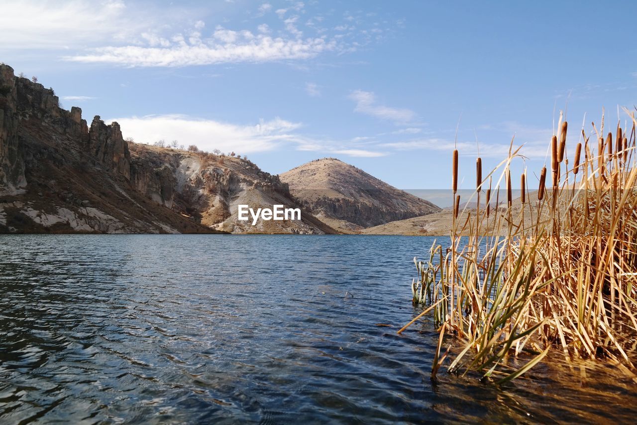 Scenic view of lake and mountains against sky