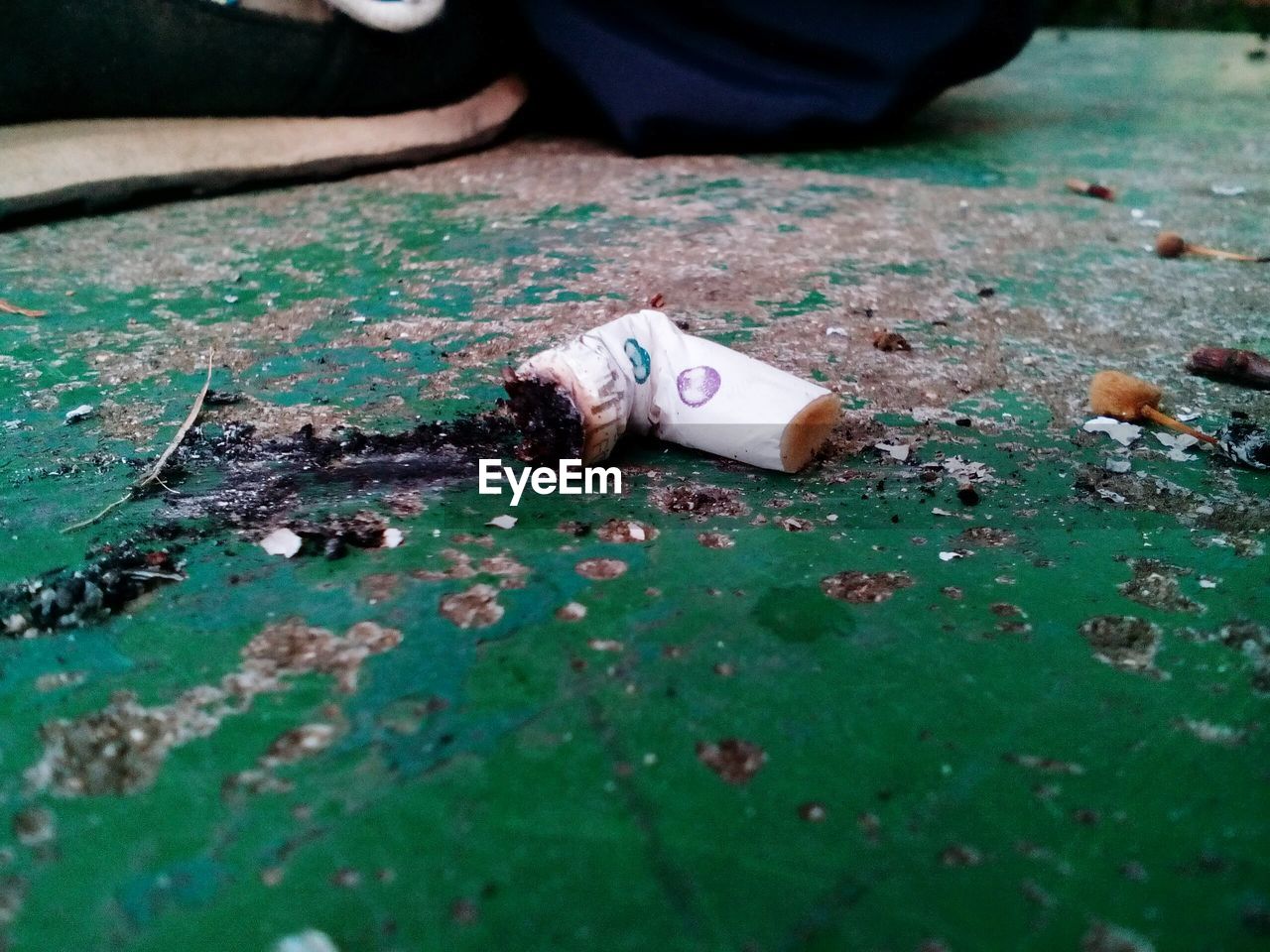 Cigarette butt on footpath