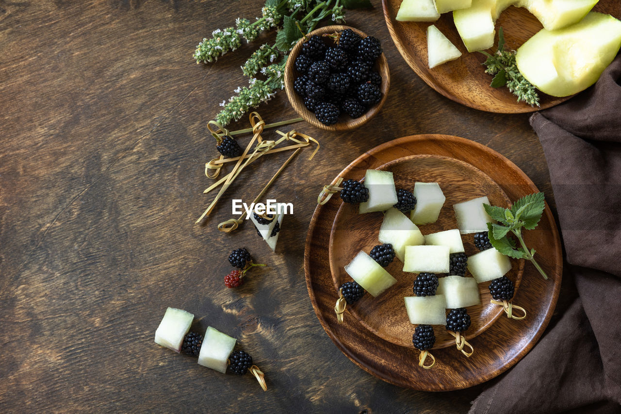 Festive snack of fruit and berry canapes. halloween party food. canapes with melon and blackberries 