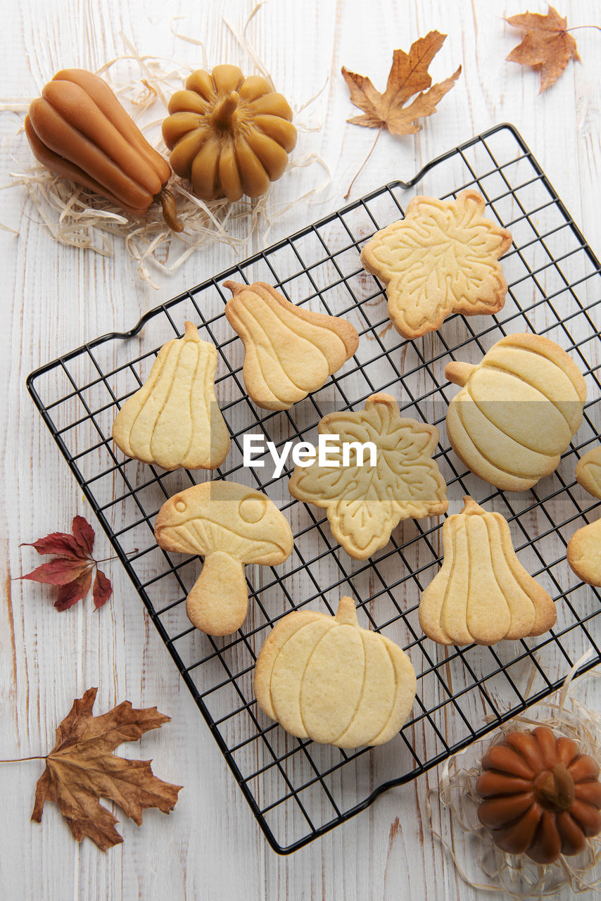 Autumn baking. cookies in the form of pumpkin and leaves on the table. cozy autumn concept.