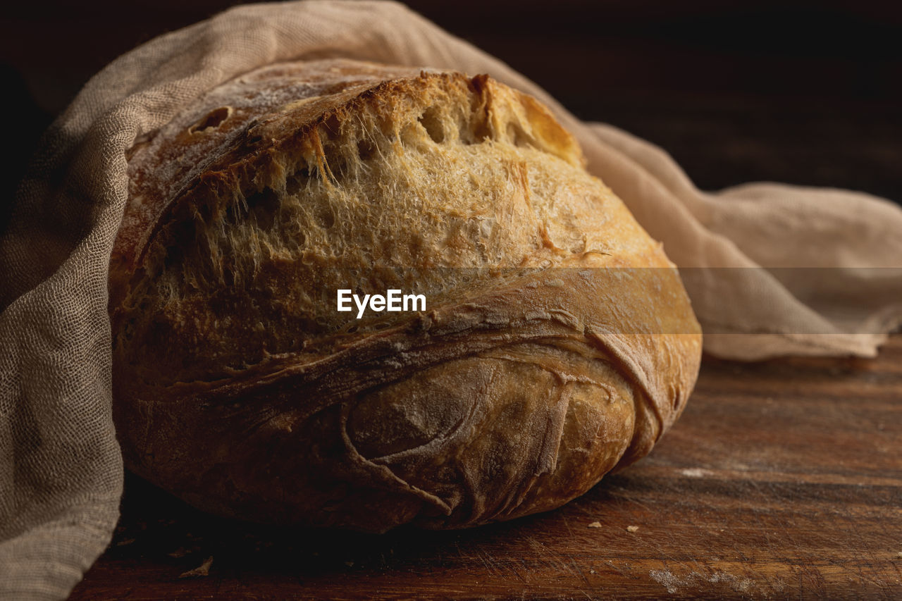 Closeup of homemade bread on table against dark background