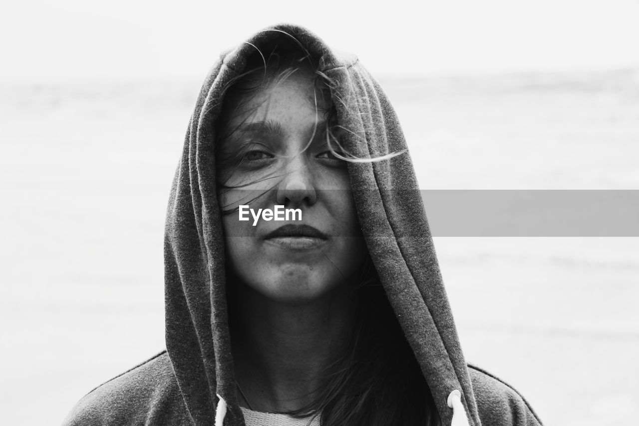 PORTRAIT OF BEAUTIFUL YOUNG WOMAN AGAINST SKY