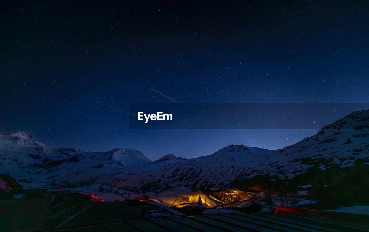 scenic view of snowcapped mountains against star field