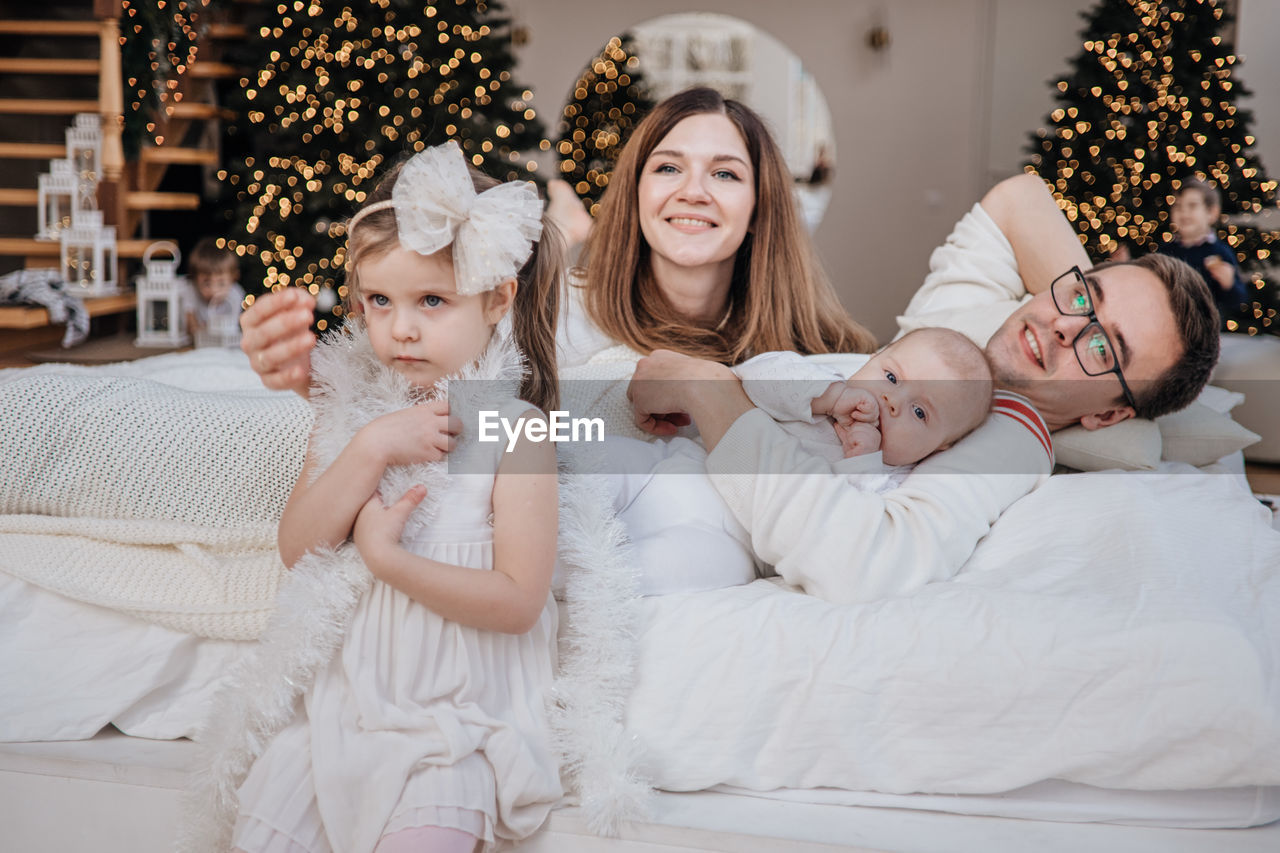 High angle view of mother and daughter lying on bed at home