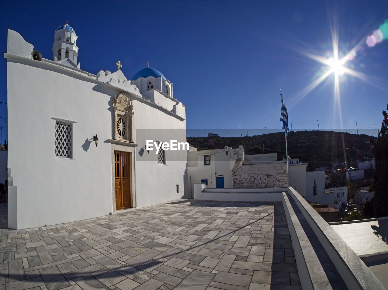 FOOTPATH AMIDST BUILDINGS AGAINST CLEAR SKY