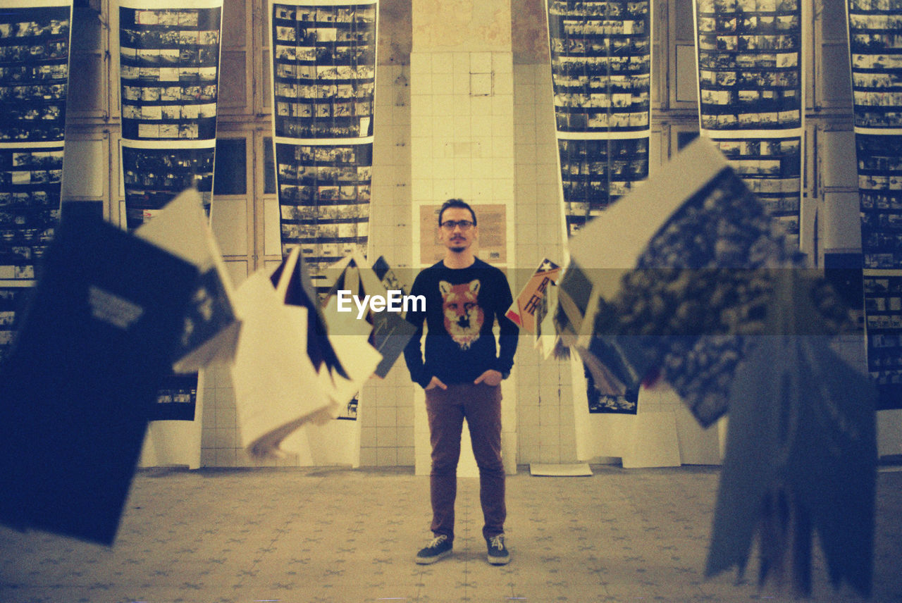 Low angle view of man standing in front of wall