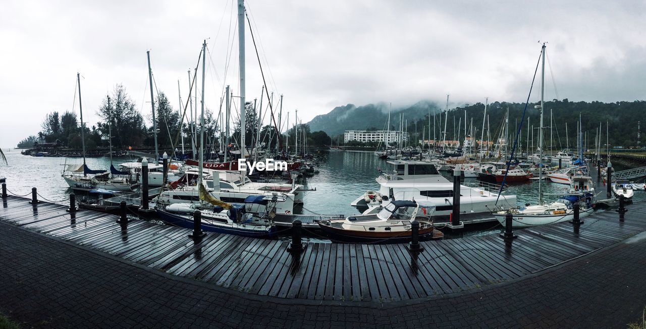 SAILBOATS MOORED IN MARINA