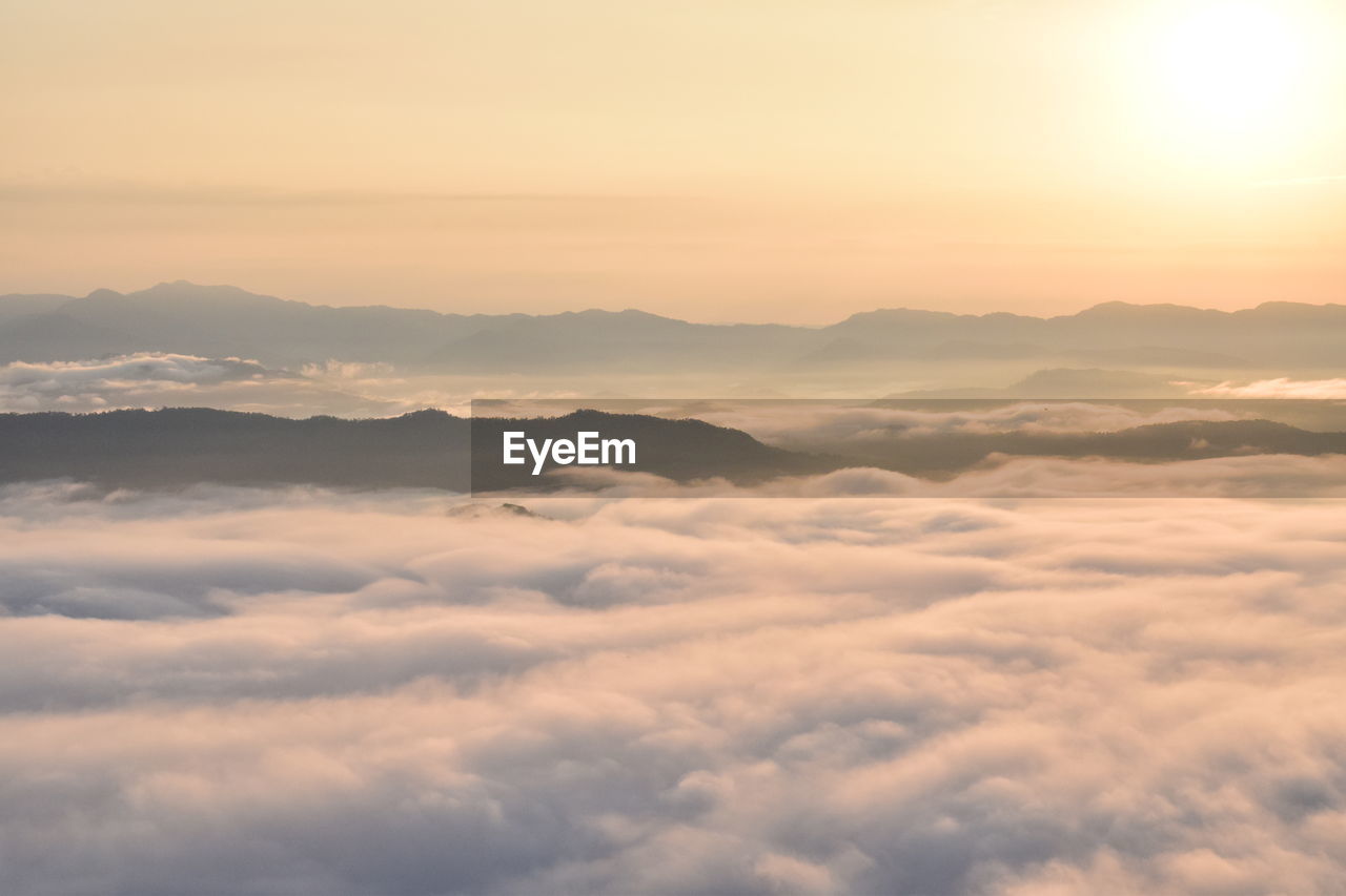 scenic view of mountains against sky at sunset