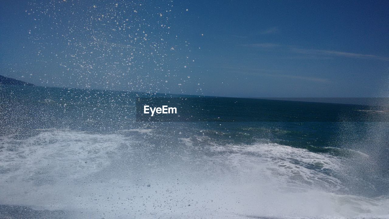 CLOSE-UP OF SEA AGAINST BLUE SKY