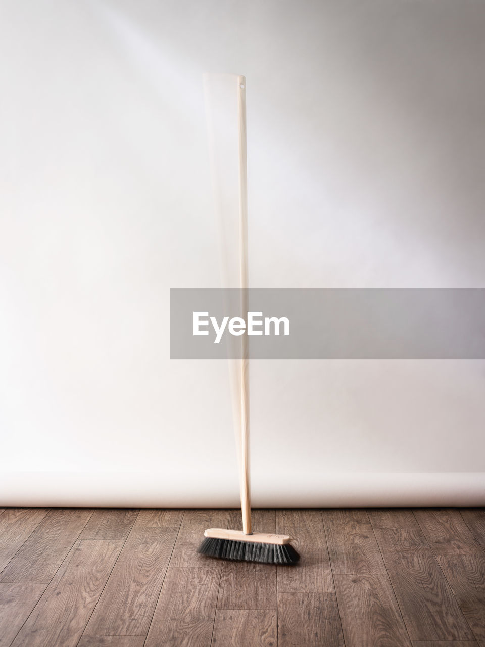 High angle view of broom on floor by wall at home
