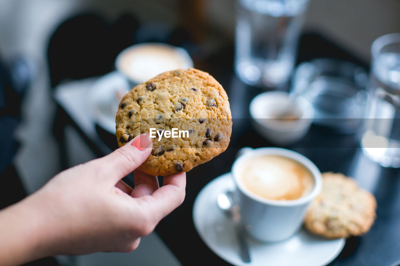 Cropped hand of woman holding cookie