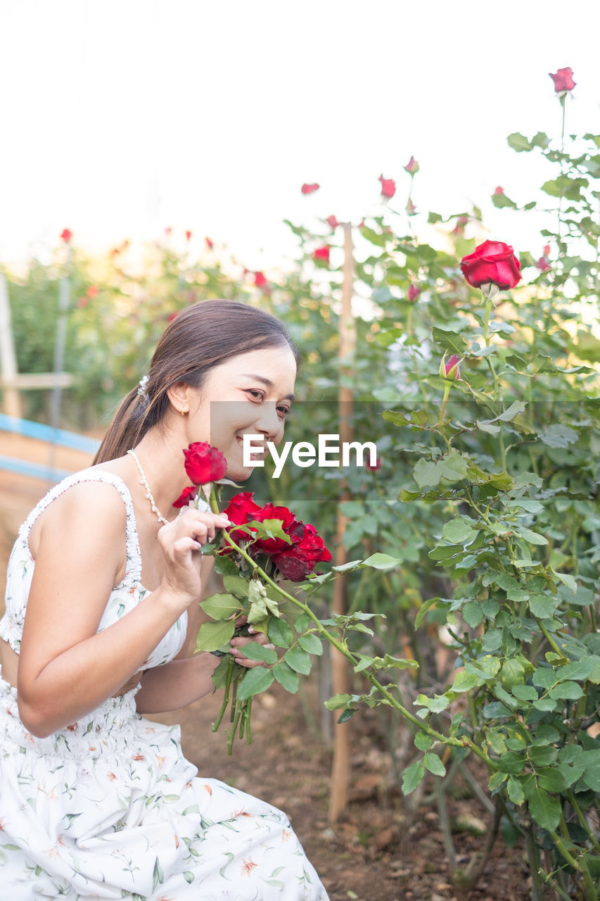 portrait of smiling young woman with flowers