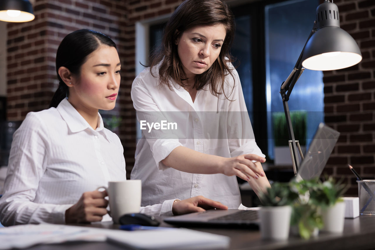 Female friends working at office