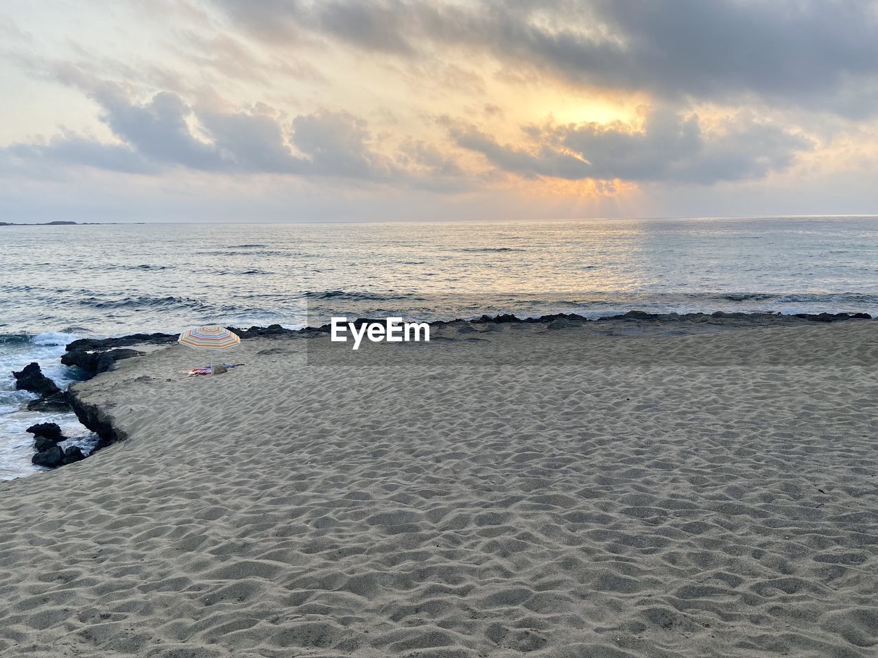 sea, land, beach, water, sky, shore, body of water, ocean, wave, sand, beauty in nature, scenics - nature, cloud, sunset, coast, nature, horizon over water, horizon, wind wave, tranquility, motion, environment, seascape, tranquil scene, travel destinations, holiday, travel, vacation, trip, coastline, outdoors, dramatic sky, landscape, idyllic, sports, no people, sun, tourism, dusk, water sports, bay, sunlight, water's edge, day, non-urban scene, urban skyline, summer, relaxation