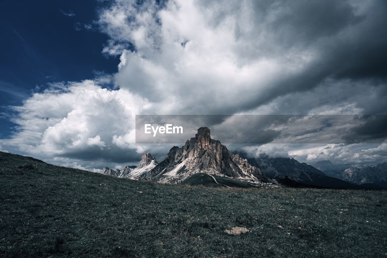 Panoramic view of land and mountains against sky