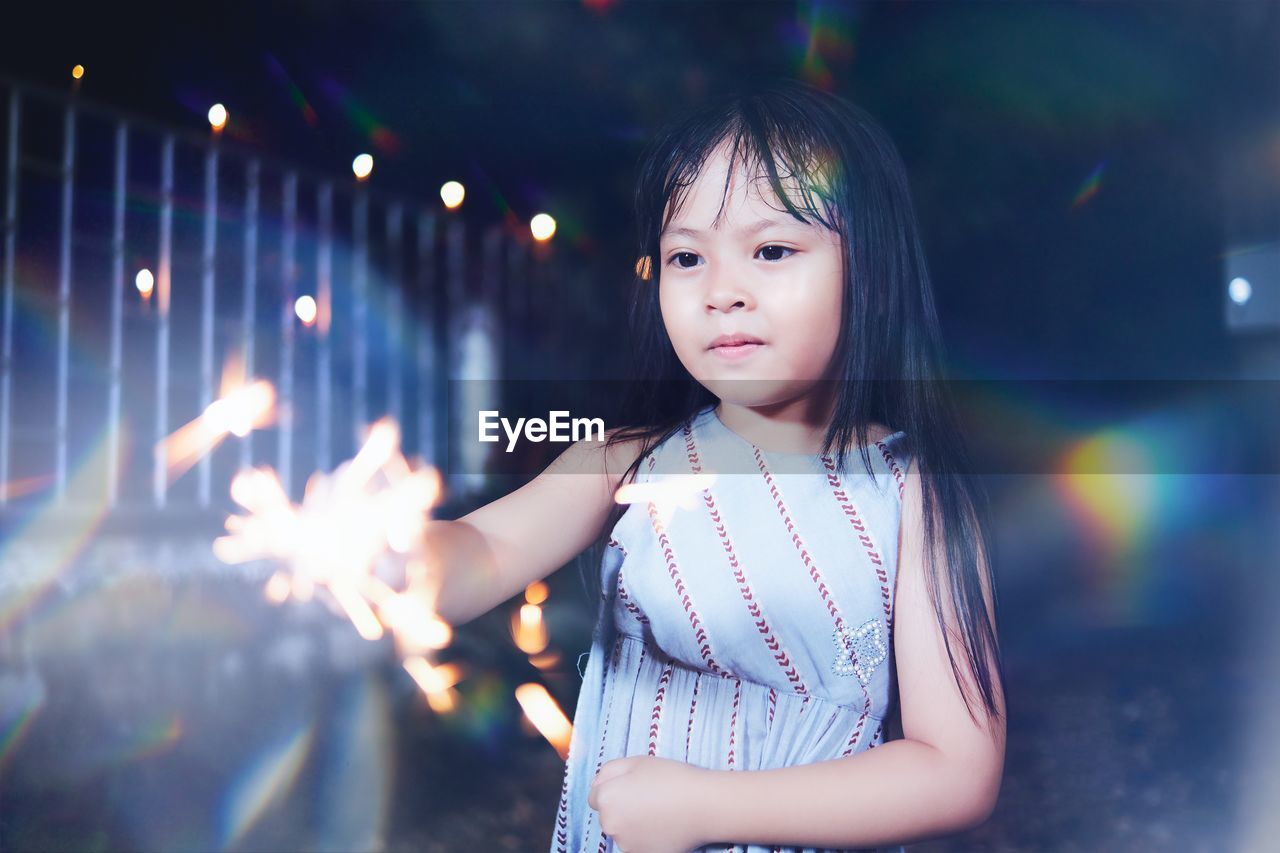 Child playing fireworks in new year celebration at night