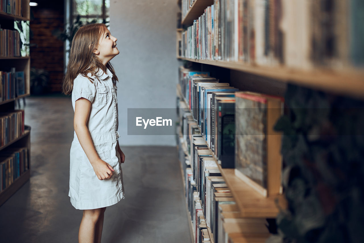 Student choosing book in school library. back to school. learning and fun. primary education. learn