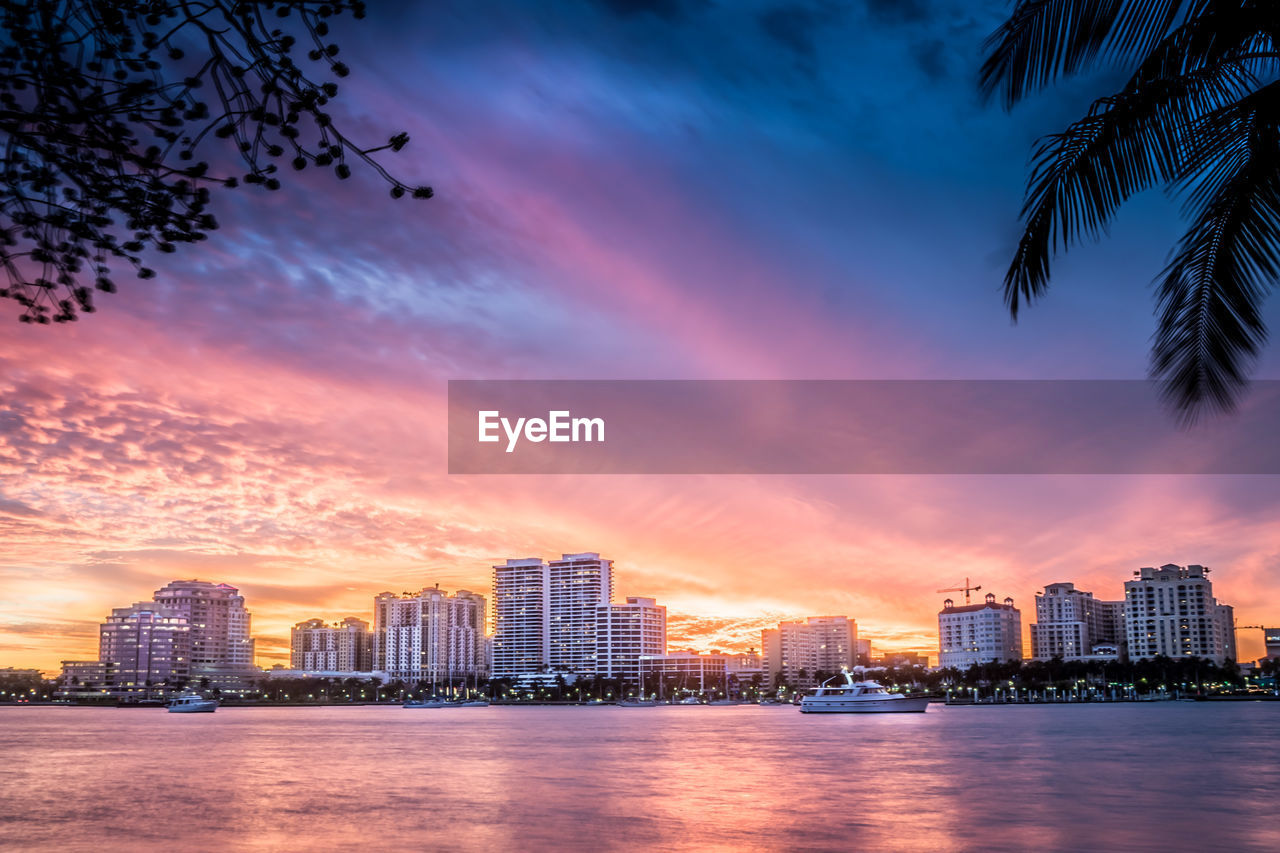 City at waterfront during sunset