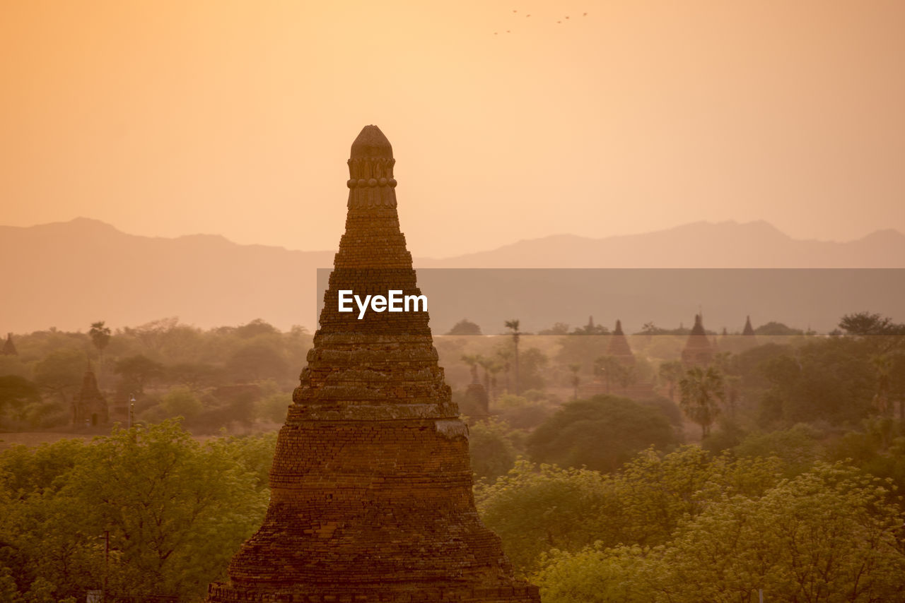 Stupa against clear sky during sunset