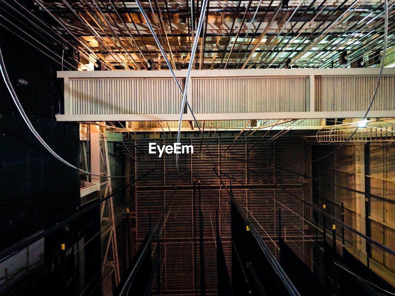 LOW ANGLE VIEW OF ILLUMINATED CEILING AT CONSTRUCTION SITE