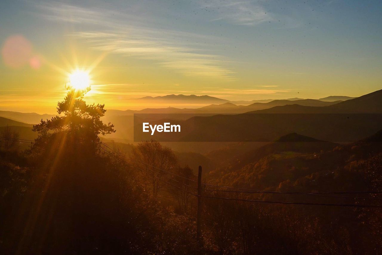 Scenic view of mountains against sky during sunset