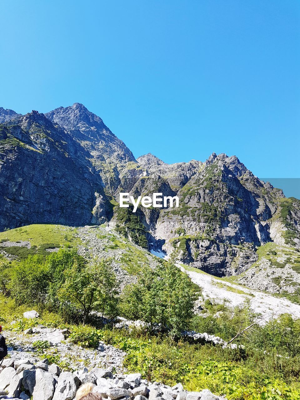 SCENIC VIEW OF MOUNTAIN AGAINST BLUE SKY