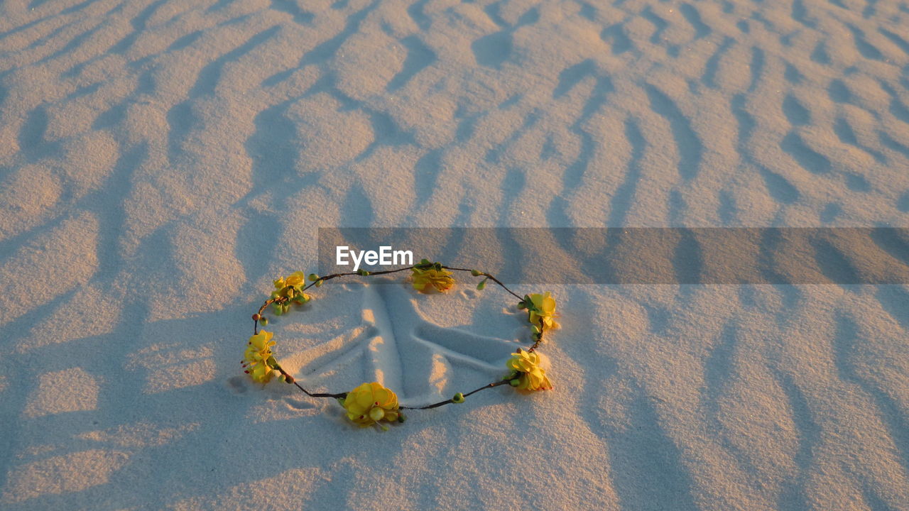 Close-up of floral headband on sand