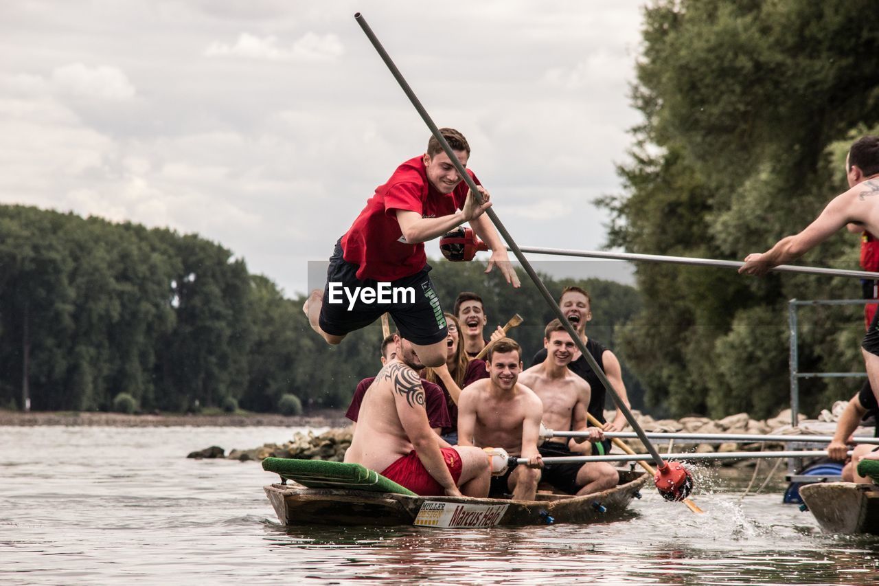 MEN SITTING IN RIVER