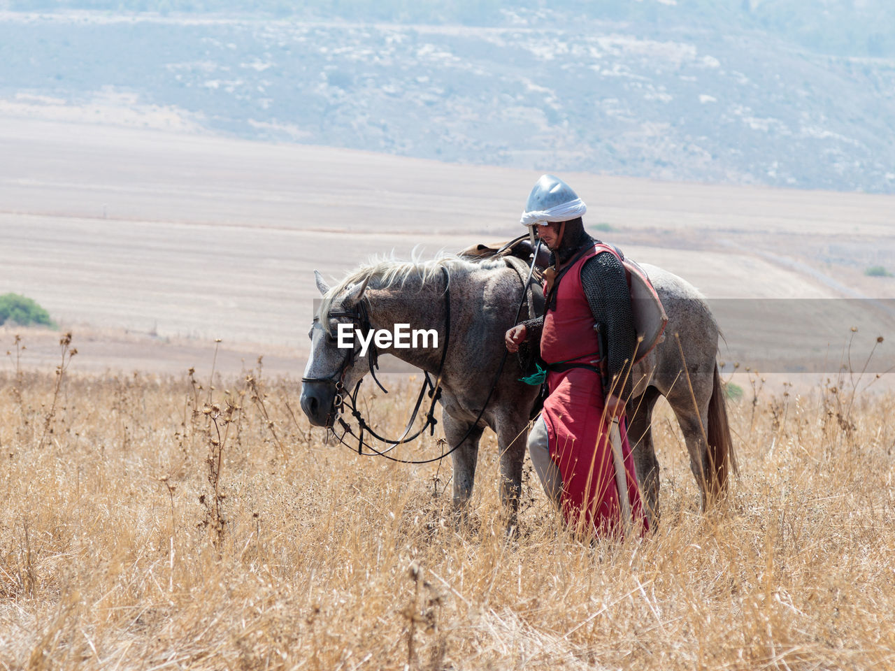 MAN WORKING ON FIELD AT FARM