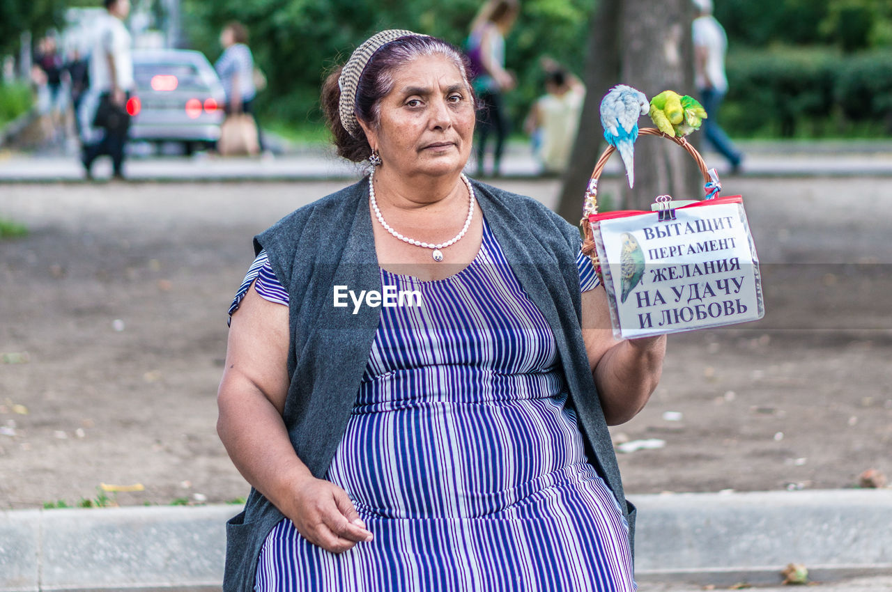 FULL LENGTH OF WOMAN STANDING BY STREET