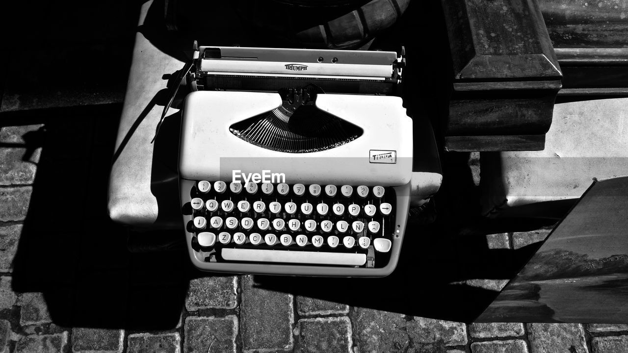 HIGH ANGLE VIEW OF TEXT ON OLD TABLE