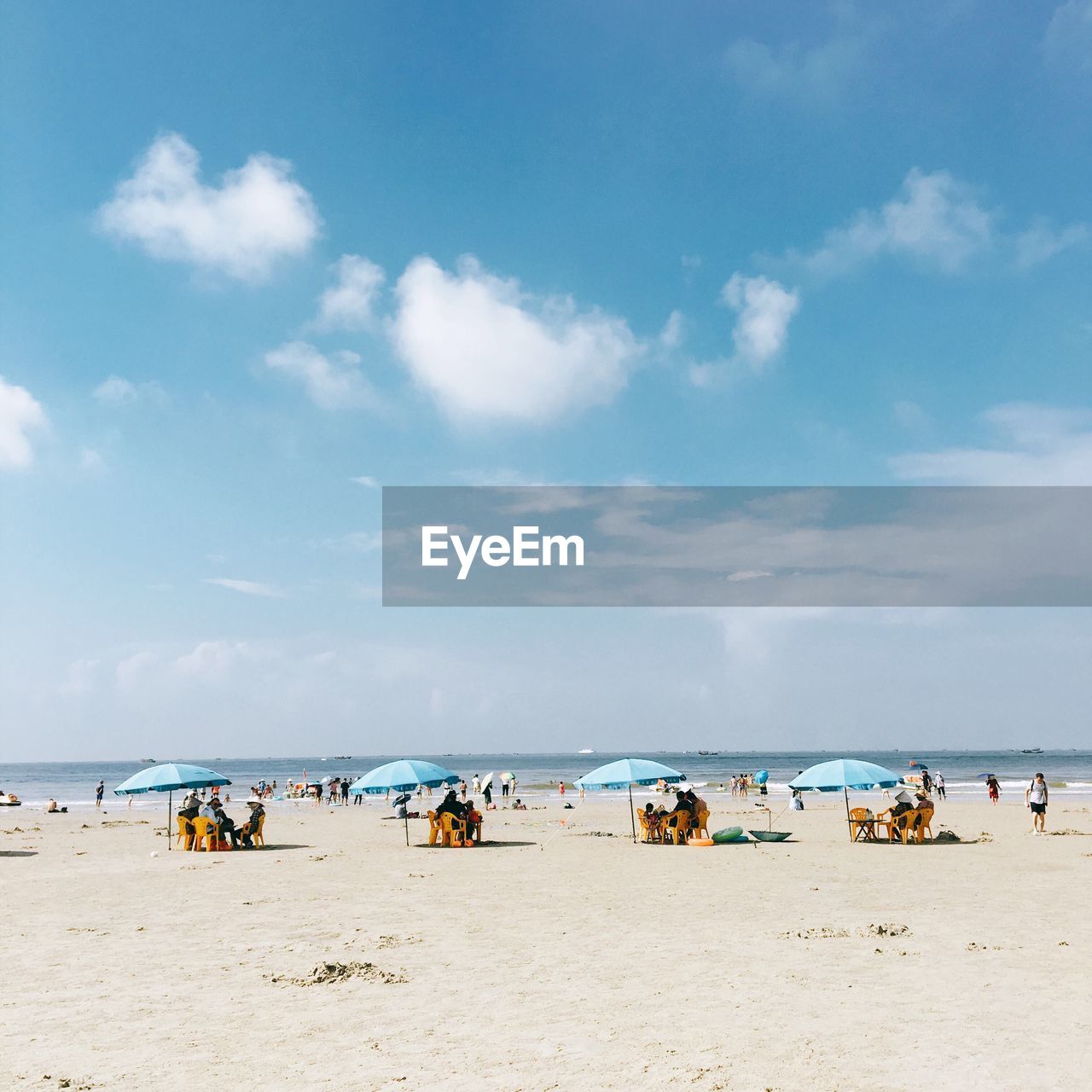 PEOPLE ON BEACH AGAINST SKY