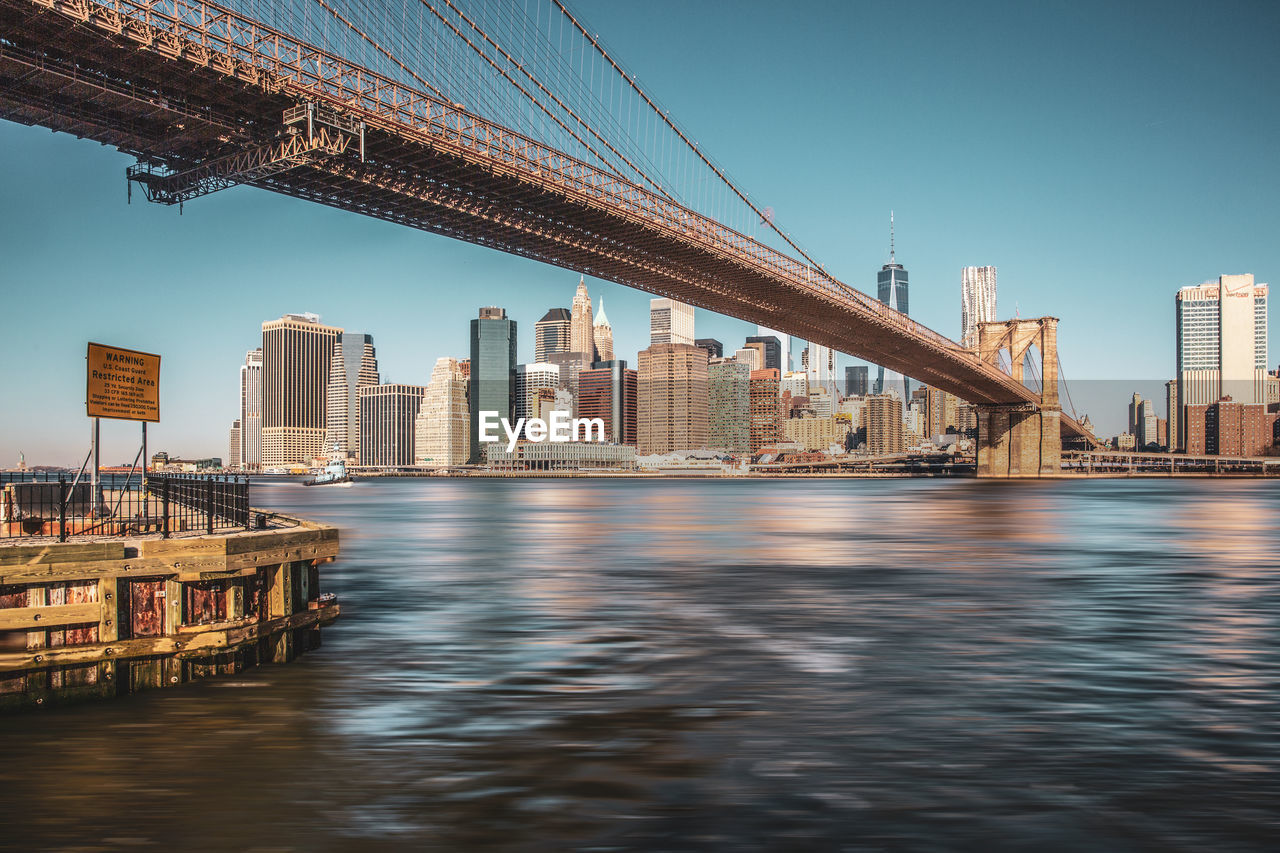 Bridge over river with buildings in background