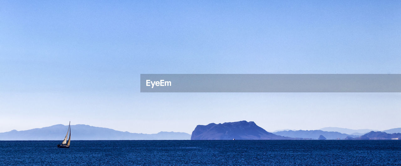 Sailboat in sea against sky
