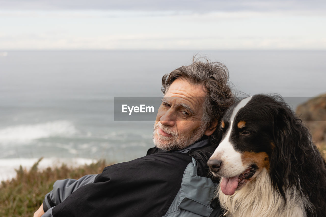 Happy mature man looking at his dog